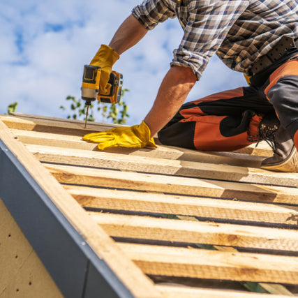 Do-It-YourselfA contractor using a power drill to install a roof