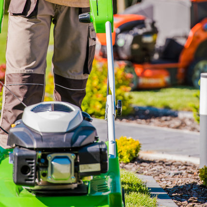 LandscapingA close up of a push mower with a riding mower in the background 